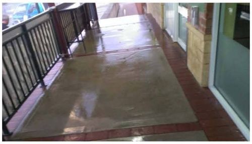 Commercial paving restored to clean surface after high-pressure cleaning